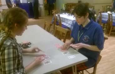 Between perfomances, Annie (Beth) and Billy (Ruth) practice Billy's card game